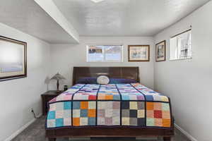 Bedroom with carpet floors and a textured ceiling