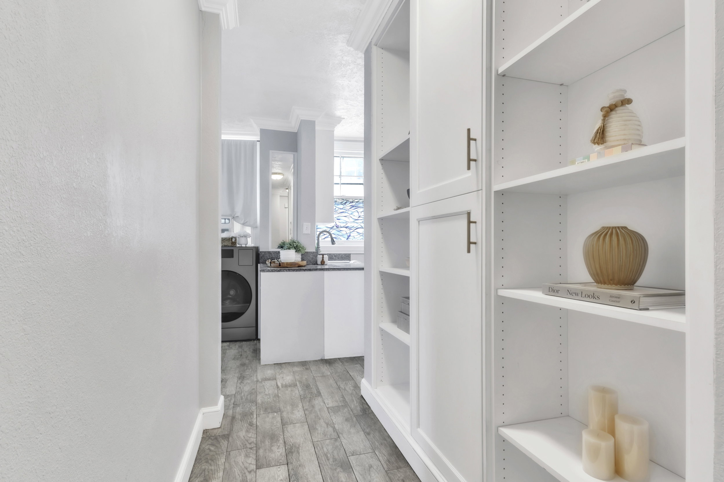 Walk in closet featuring light wood-type flooring and washer / dryer