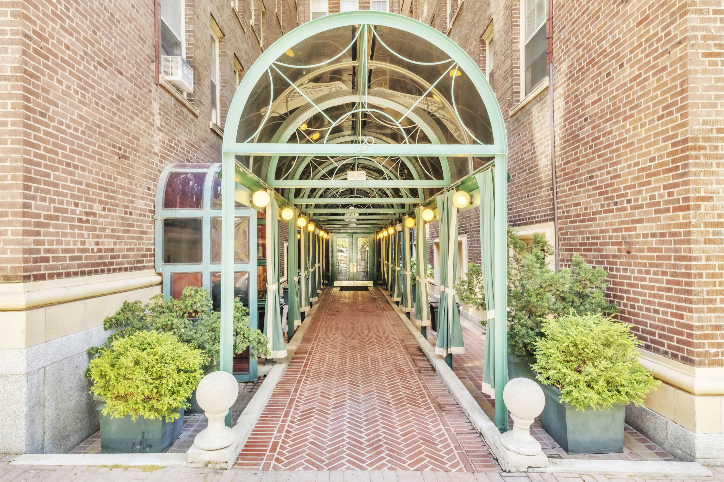 Entrance to property featuring brick siding and french doors