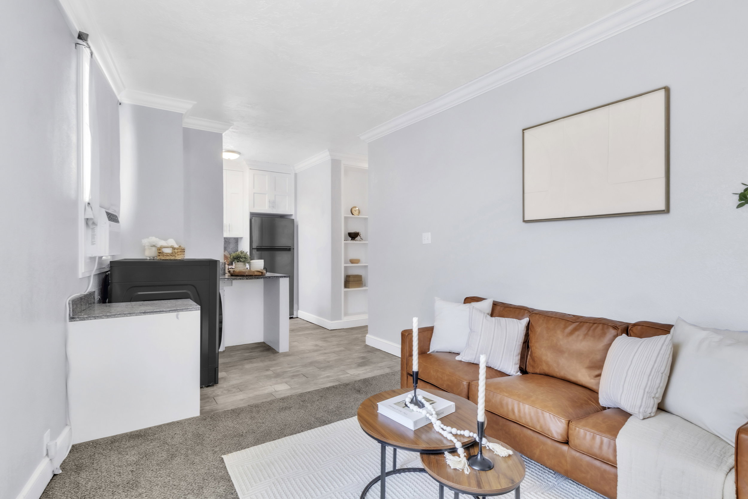 Living room with crown molding, washer / clothes dryer, and light colored carpet