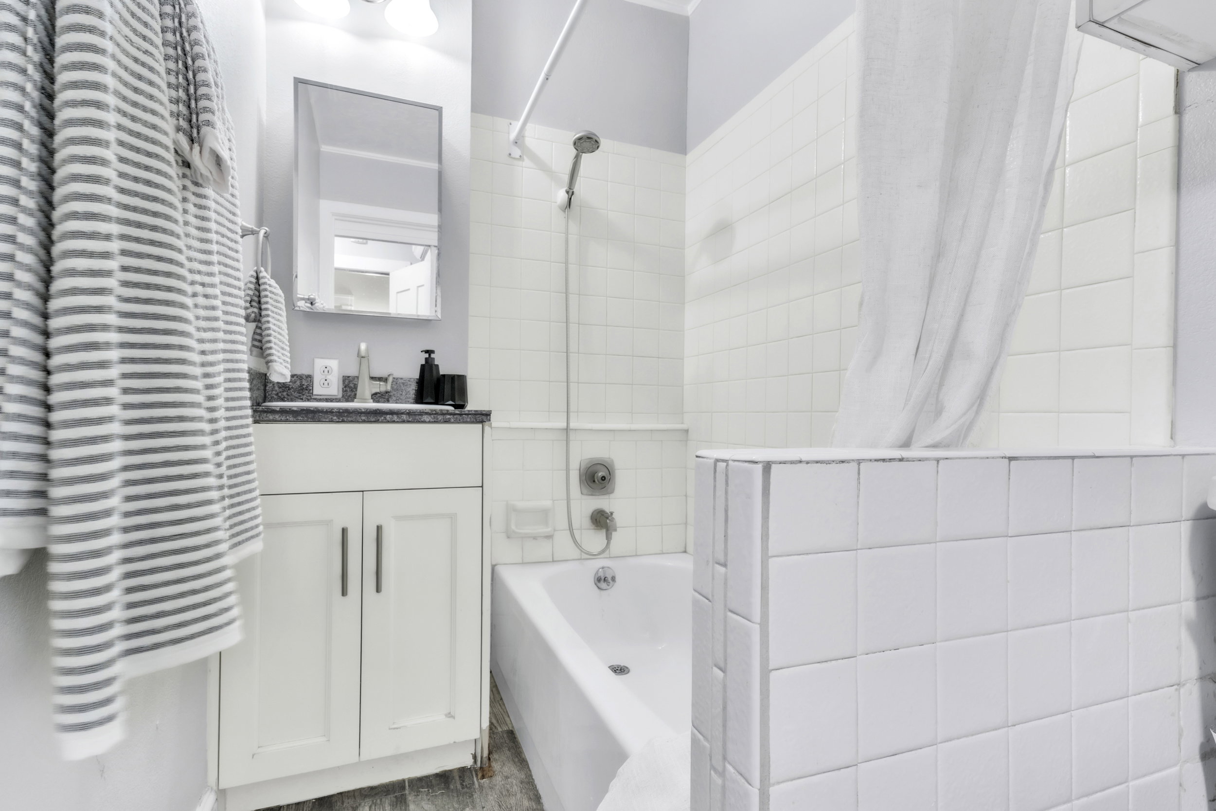 Full bathroom featuring vanity and shower / bathtub combination with curtain
