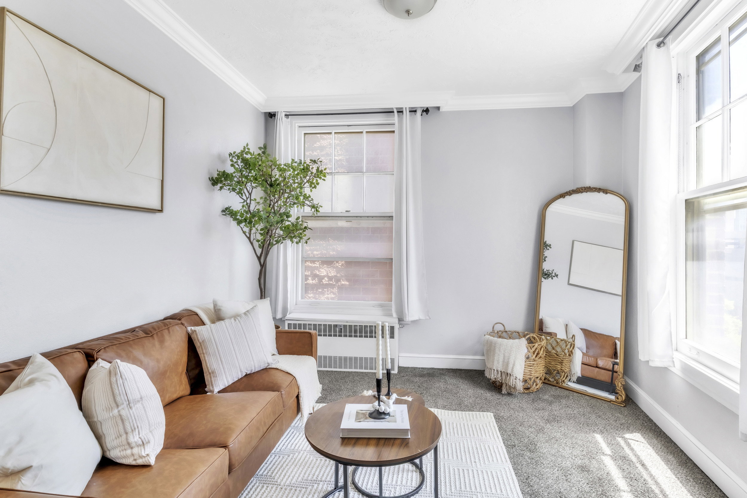 Living area featuring carpet flooring, ornamental molding, and radiator heating unit