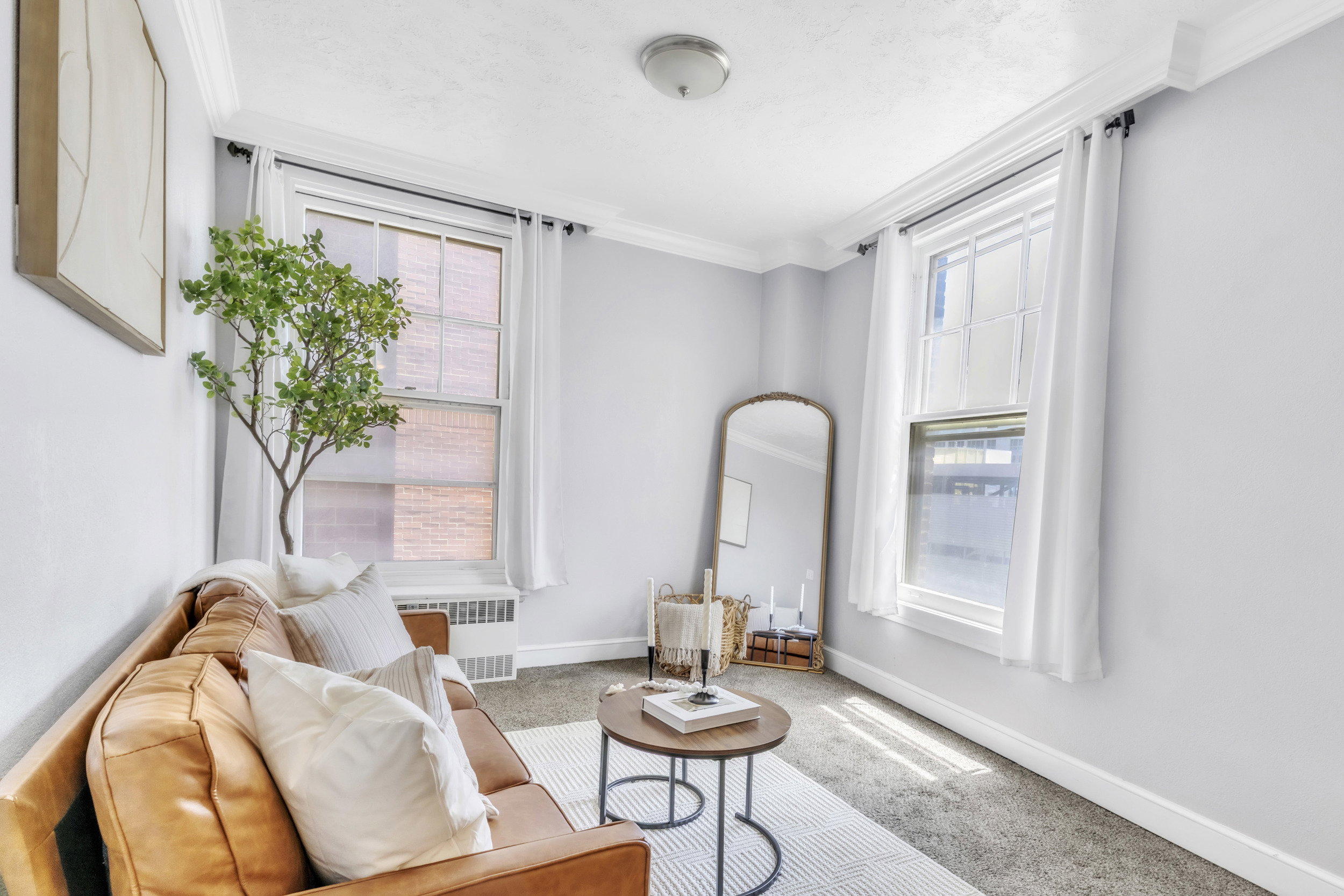 Living area featuring ornamental molding, carpet flooring, and radiator heating unit