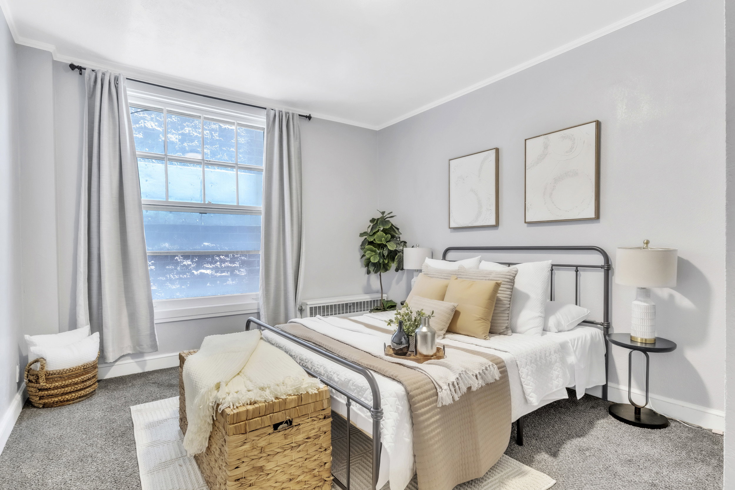 Bedroom featuring light colored carpet, ornamental molding, and radiator