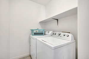 Laundry room featuring separate washer and dryer and baseboards