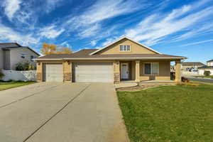 View of front of house featuring stucco siding, a porch, a garage, and driveway