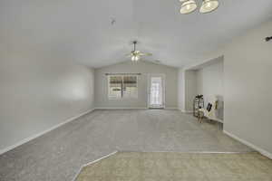 Unfurnished room featuring light colored carpet and a ceiling fan