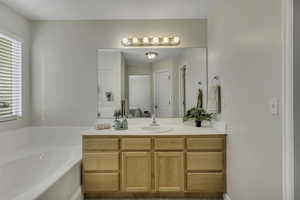 Bathroom with vanity and a garden tub