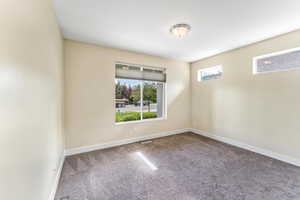 Empty room featuring carpet floors and baseboards