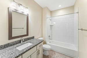 Full bath with vanity, bathing tub / shower combination, and light tile patterned floors