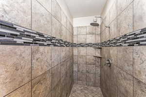 Full bath with a tile shower