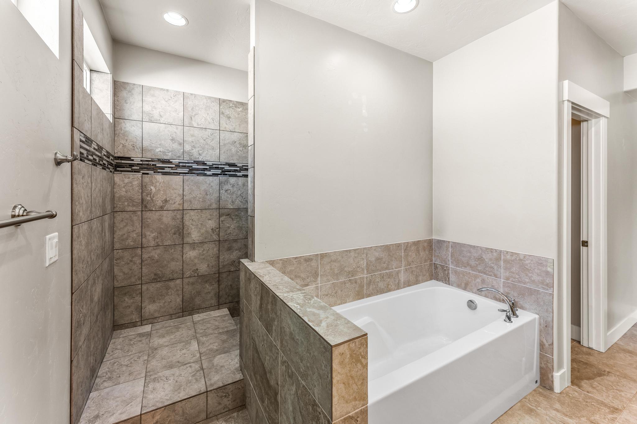 Full bathroom featuring a garden tub, a walk in shower, and recessed lighting