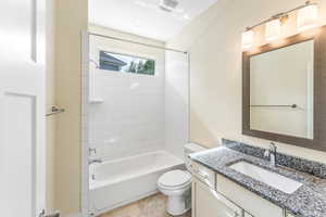 Bathroom with vanity and tub / shower combination