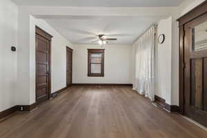 Unfurnished bedroom featuring dark wood finished floors and ceiling fan