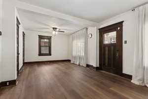 Foyer entrance featuring dark wood-style flooring and ceiling fan