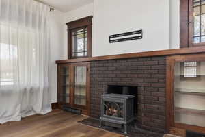 Detailed view of wood finished floors and a wood stove