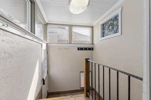 Stairs with baseboards and crown molding