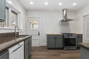 Kitchen with stainless steel range with gas cooktop, dishwasher, dark wood-style floors, and recessed lighting