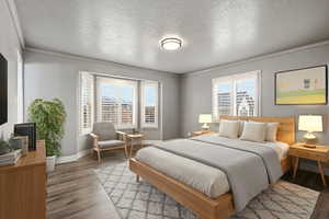 Bedroom with a textured ceiling, wood finished floors, and crown molding