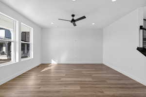 Unfurnished room featuring a ceiling fan, dark wood-style flooring, and recessed lighting