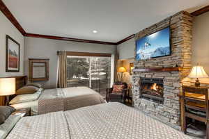Bedroom with ornamental molding, a fireplace, access to exterior, and recessed lighting