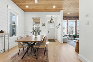 Dining room with wooden ceiling, healthy amount of natural light, recessed lighting, and light wood-style floors