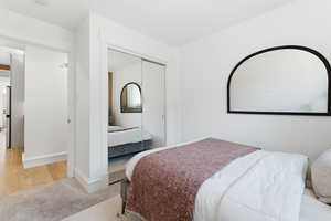 Bedroom featuring a closet and light carpet