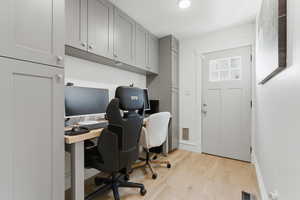 Office space with light wood finished floors and baseboards