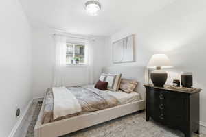 Carpeted bedroom with baseboards