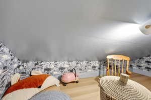 Bedroom with wood finished floors and a textured ceiling
