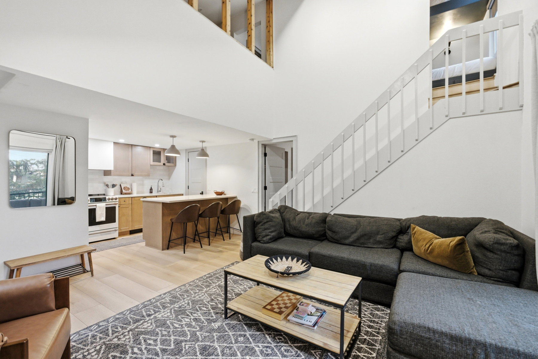 Living area featuring light wood finished floors and a high ceiling