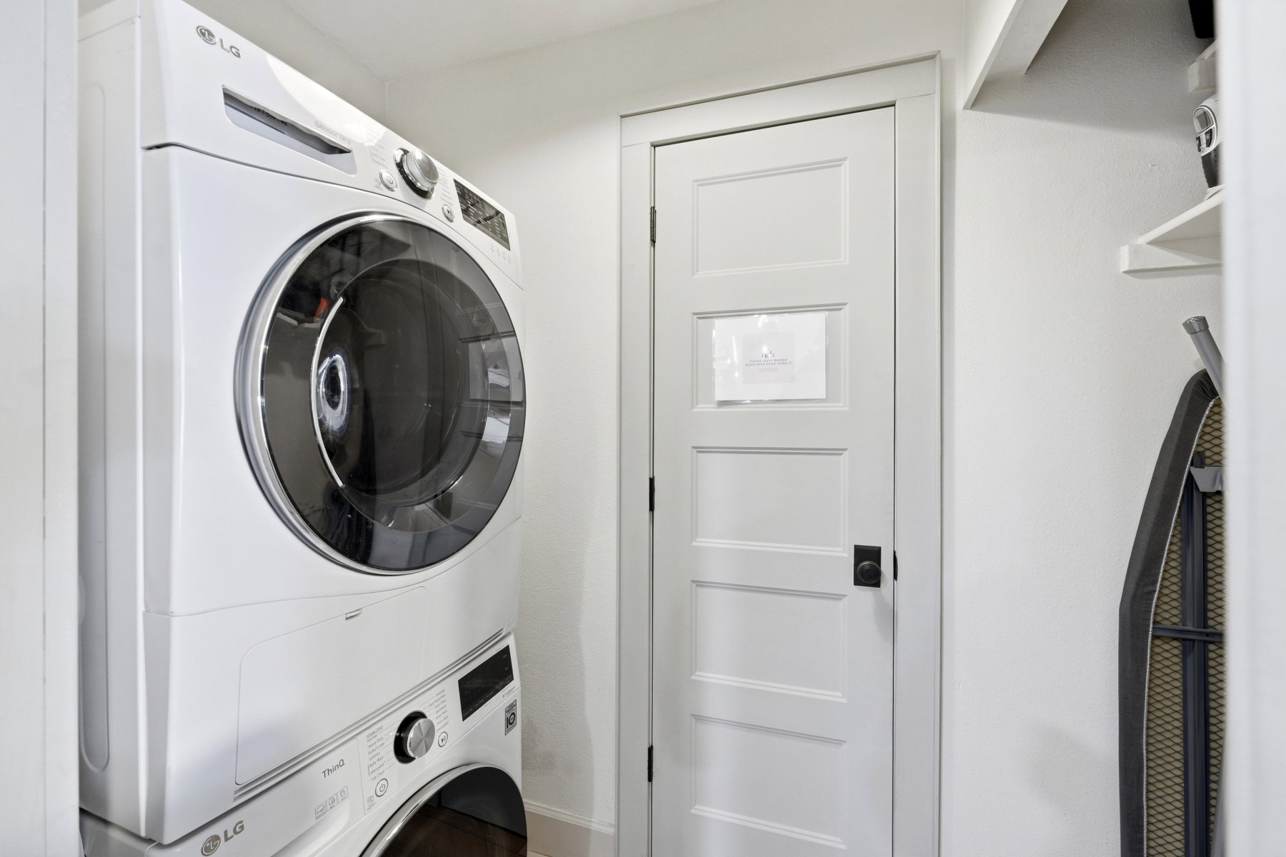Laundry area with stacked washing machine and dryer