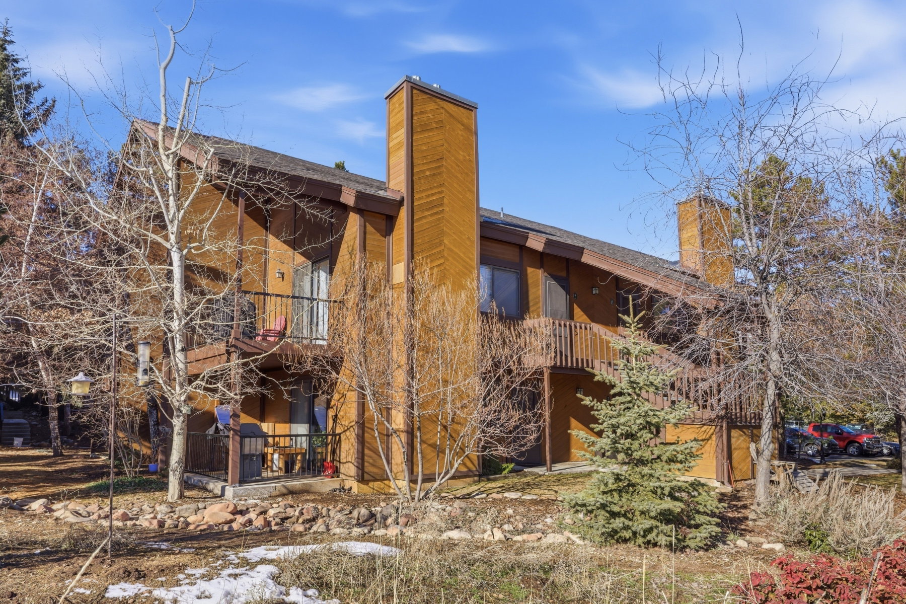 Rear view of property with a balcony and a chimney