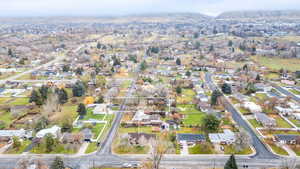 Aerial view of property and surrounding area featuring nearby suburban area