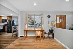 Dining room with light wood-type flooring and recessed lighting