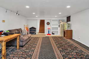 Carpeted living room featuring recessed lighting