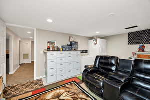 Home theater featuring light colored carpet and recessed lighting