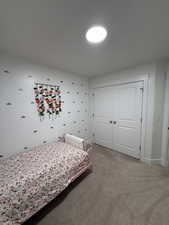 Bedroom featuring carpet and a closet