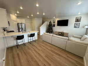 Living room featuring light wood-style floors and recessed lighting