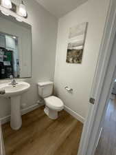 Half bath with wood finished floors