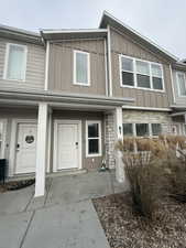 View of front of property featuring board and batten siding and stone siding
