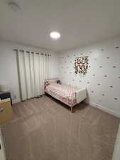 Bedroom with baseboards and carpet flooring