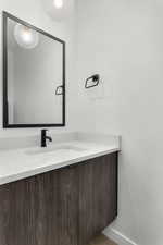 Bathroom featuring vanity and wood finished floors