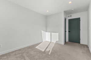 Unfurnished room featuring light carpet and recessed lighting