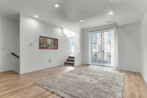 Unfurnished room featuring recessed lighting, light wood finished floors, and a textured ceiling