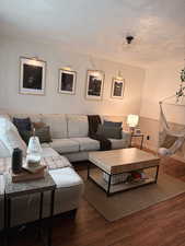 Living room with wood finished floors and a textured ceiling