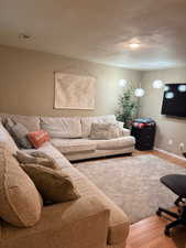 Living room featuring wood finished floors and a textured ceiling