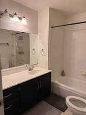 Bathroom featuring shower / bathtub combination with curtain, vanity, and light tile patterned floors