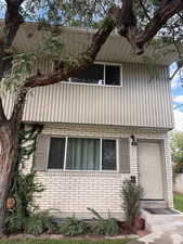 View of property exterior featuring brick siding