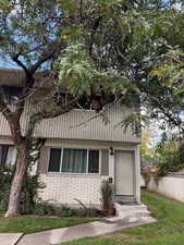 View of home's exterior featuring a yard and brick siding